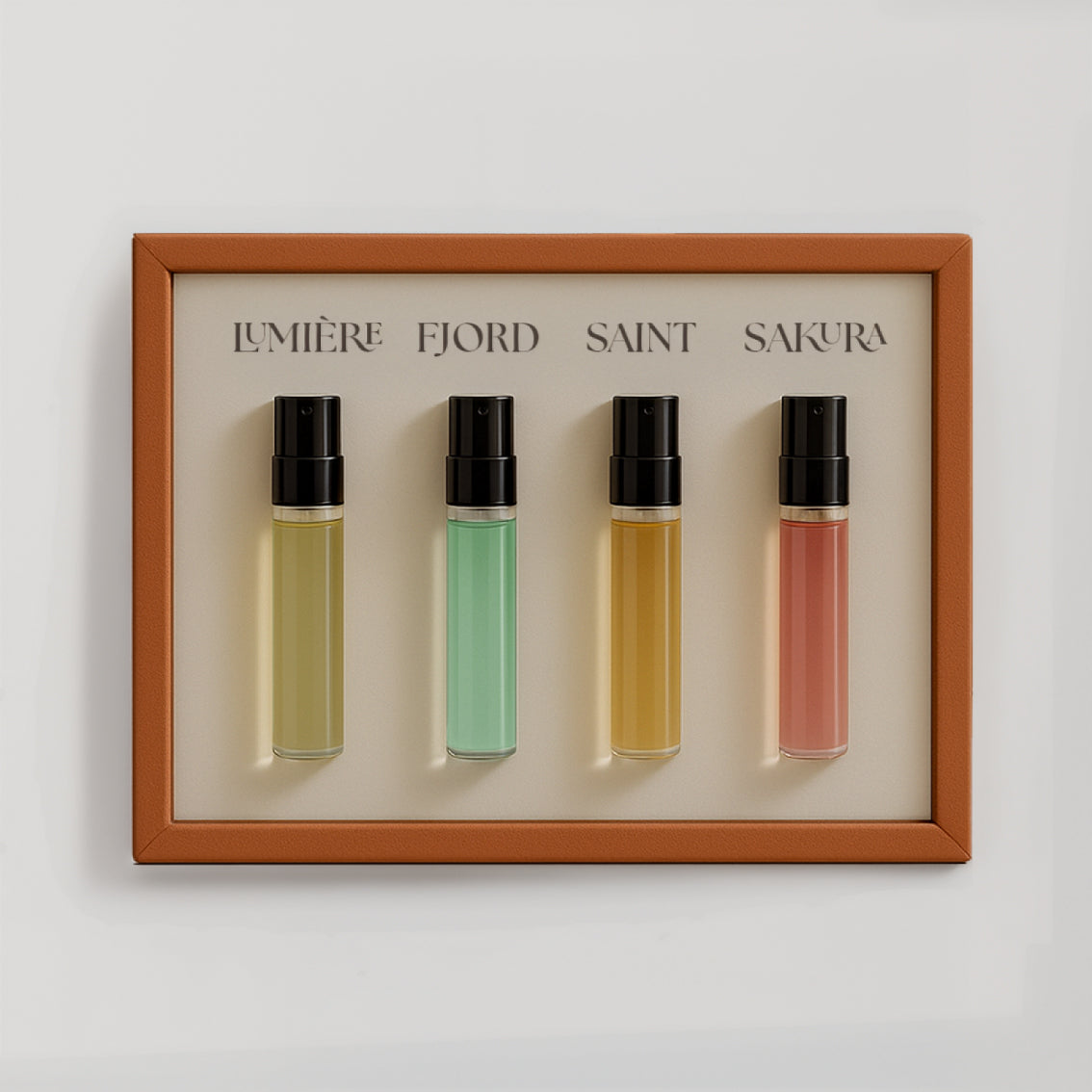 Luxury niche perfume discovery set by Le Scribe featuring four unisex fragrance vials in an orange textured frame on a clean neutral background