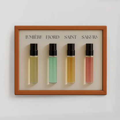 Luxury niche perfume discovery set by Le Scribe featuring four unisex fragrance vials in an orange textured frame on a clean neutral background