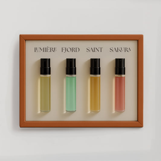 Luxury niche perfume discovery set by Le Scribe featuring four unisex fragrance vials in an orange textured frame on a clean neutral background